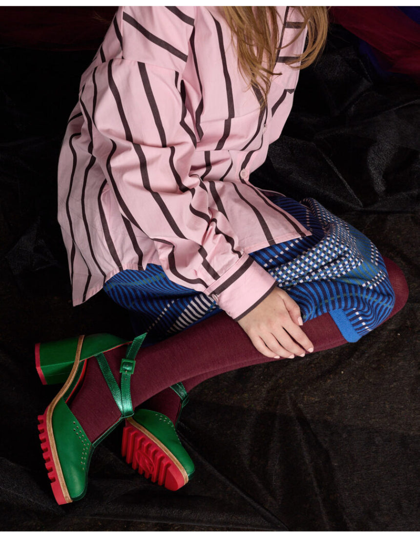 Pair of Luxe Merino Wool Tights by Tightology in deep wine color, showcasing smooth, fitted fabric and stylish design.