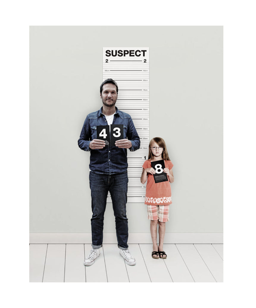 Suck UK Mugshot Height Chart featuring a vintage-style police mugshot layout with height measurements on a white background