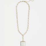 Elk Viri Gold Necklace featuring a delicate gold chain with a minimalist pendant, showcased against a neutral background.
