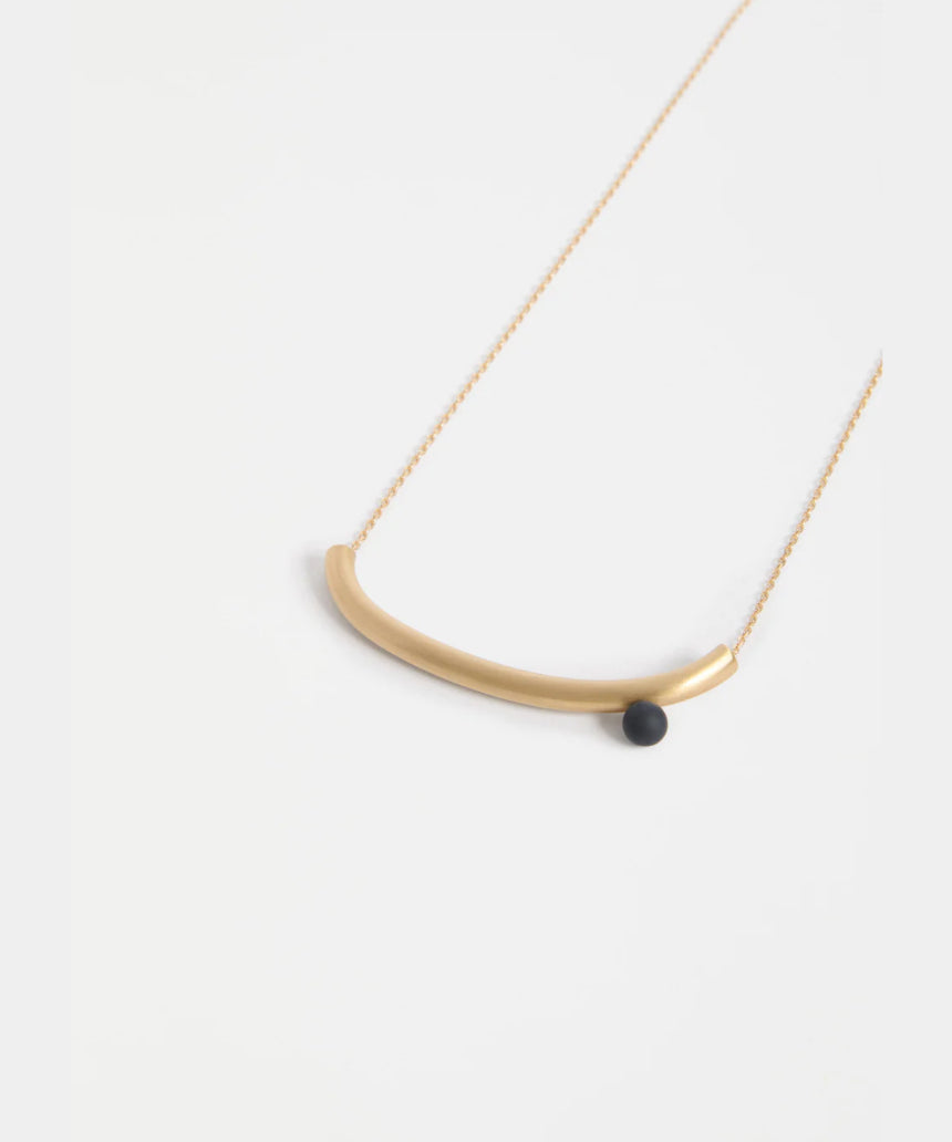 Gold Elk Ahas necklace featuring intricate pendant design, displayed on a neutral background.