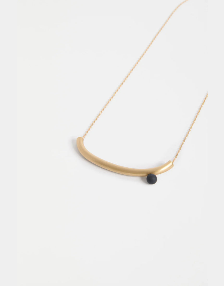 Gold Elk Ahas necklace featuring intricate pendant design, displayed on a neutral background.