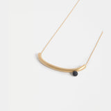 Gold Elk Ahas necklace featuring intricate pendant design, displayed on a neutral background.