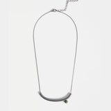 Elk Ahas necklace in gunmetal, featuring a sleek, modern pendant with a polished finish on a matching chain.