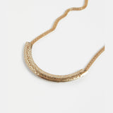 Gold Elk Hulle Necklace featuring a sleek, minimalist design with a delicate chain and subtle pendant.