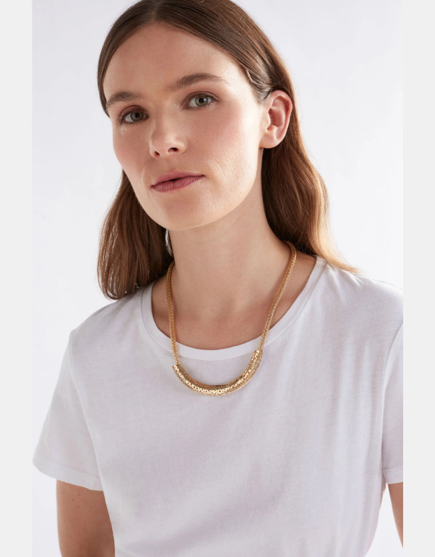 Elk Hulle Necklace in gold, featuring a delicate chain and minimalist pendant, worn around the neck.