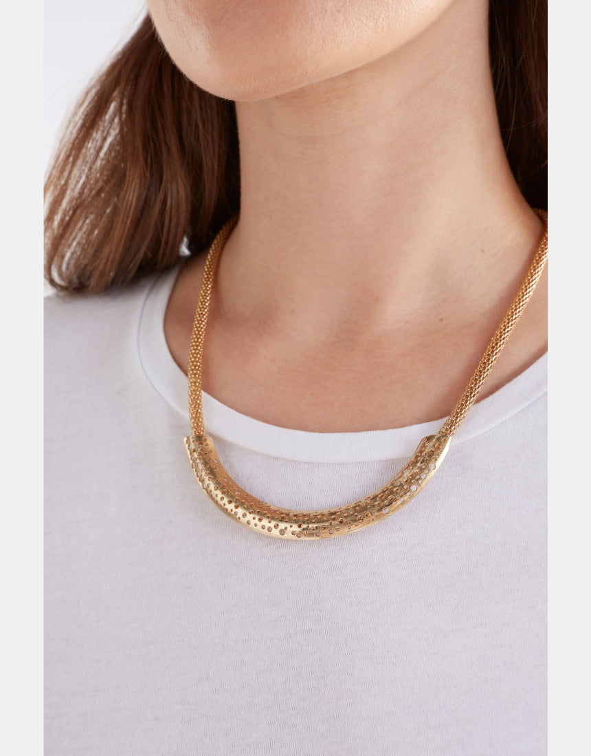 Gold Elk Hulle necklace featuring a delicate chain with a simple, elegant pendant, displayed on a neutral background.