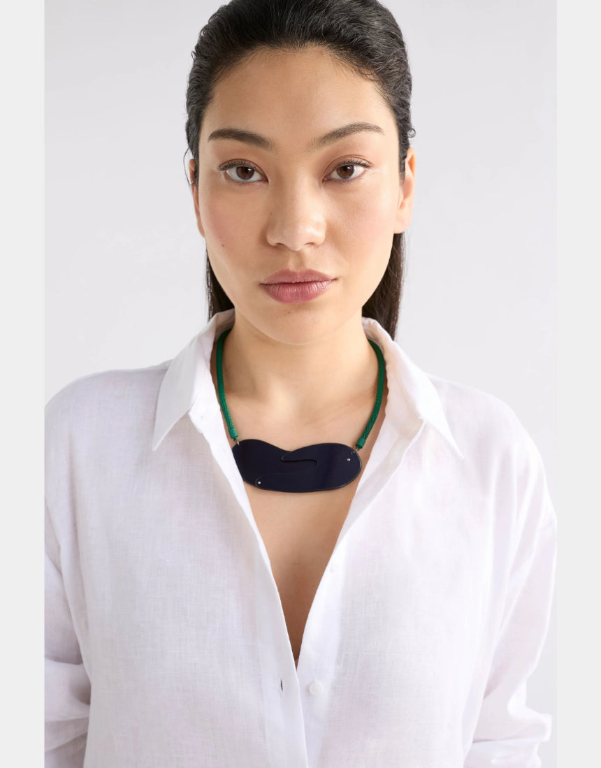 Elk Neve Necklace in new navy, featuring a sleek chain and minimalist pendant, displayed on a neutral background.