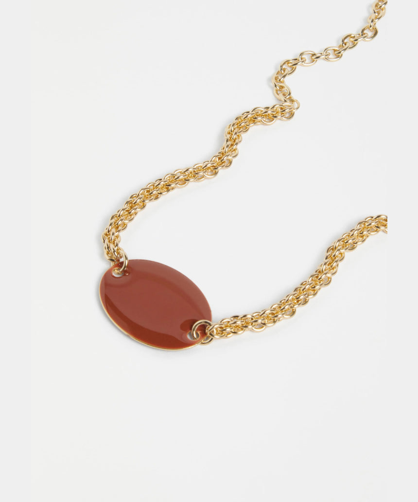 Elk Innfellt necklace with spice-colored pendant featuring intricate design on a silver chain.