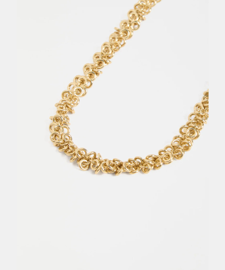 Gold Elk Hava Necklace with intricate chain and pendant, showcasing elegant design on a neutral background.