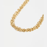 Gold Elk Hava Necklace with intricate chain and pendant, showcasing elegant design on a neutral background.