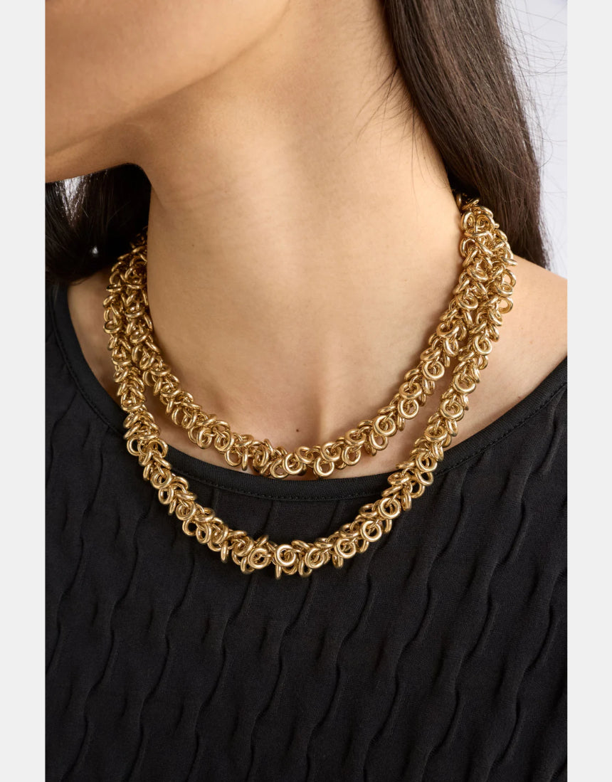 Gold Elk Hava Necklace featuring a delicate chain and intricate pendant design, displayed on a neutral background.
