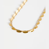 Elk Fossen necklace in gold with delicate chain and pendant, showcasing elegant jewelry design.