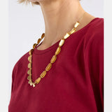 Elk Fossen Necklace in gold with delicate chain and pendant, showcasing elegant jewelry craftsmanship.