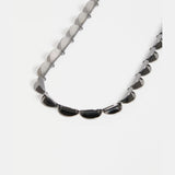Elk Fossen Necklace in gunmetal with layered chain design, featuring a modern, minimalist style for everyday wear.