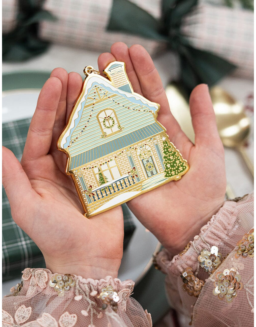 Bespoke Letterpress fine enamel Christmas house ornament hanging on a festive tree branch.