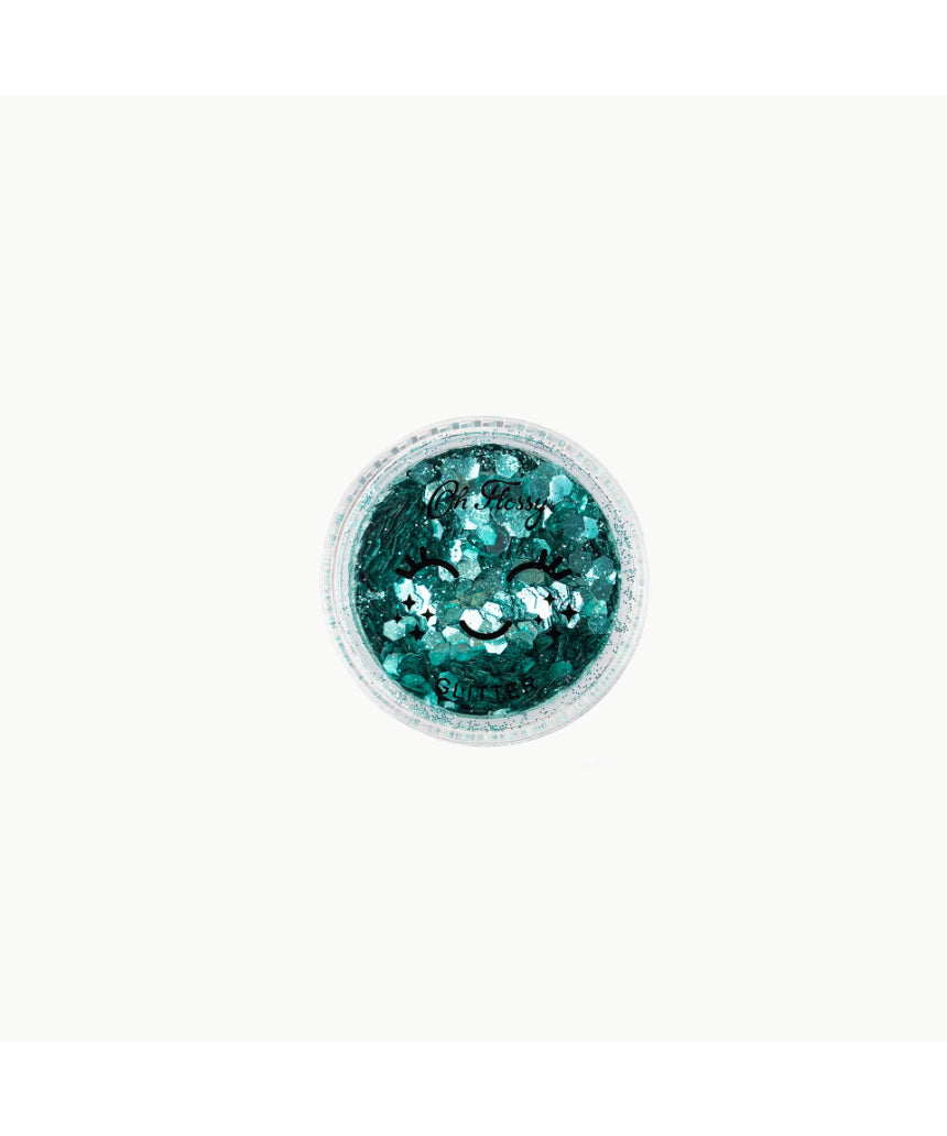 Biodegradable mint green glitter from Oh Flossy, designed for kids' makeup and creative crafts, shown in a natural setting.