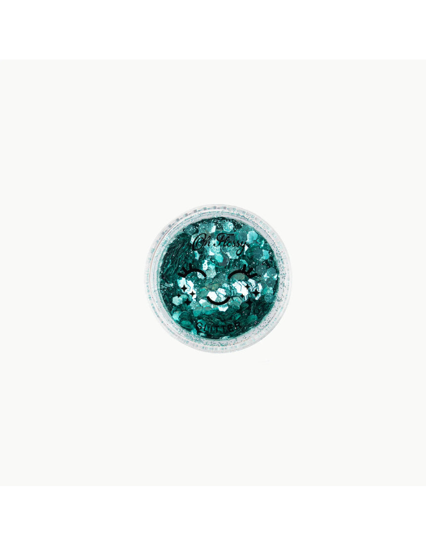 Biodegradable mint green glitter from Oh Flossy, designed for kids' makeup and creative crafts, shown in a natural setting.