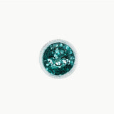 Biodegradable mint green glitter from Oh Flossy, designed for kids' makeup and creative crafts, shown in a natural setting.