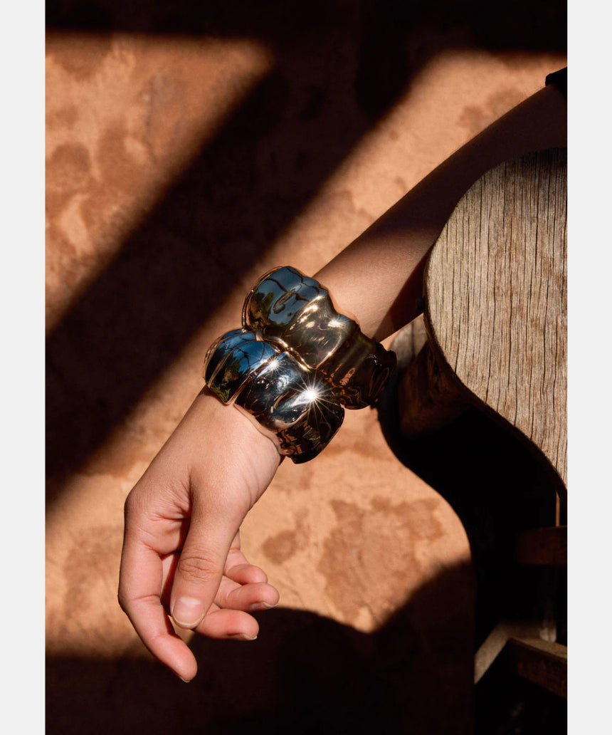 Elk Dalen Bangle Gold bracelet featuring a sleek, minimalist gold design with smooth finish and subtle branding.