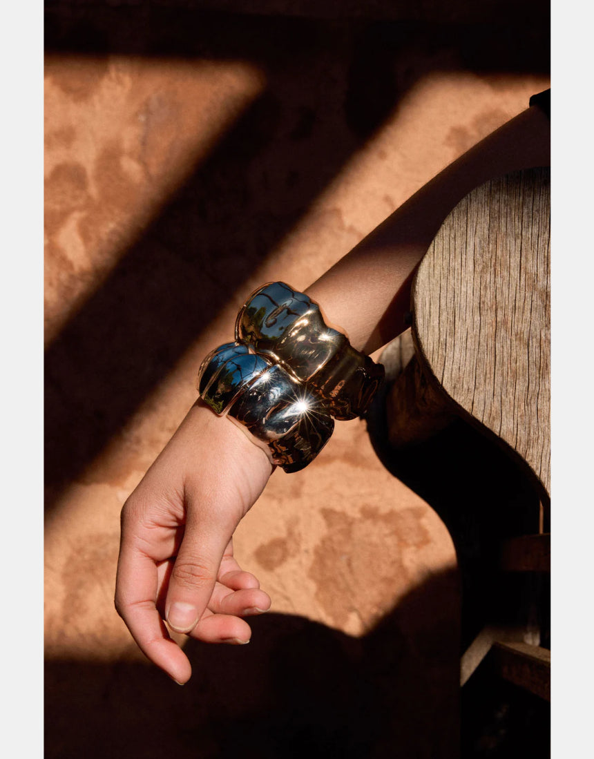 Elk Dalen Bangle Gold bracelet featuring a sleek, minimalist gold design with smooth finish and subtle branding.