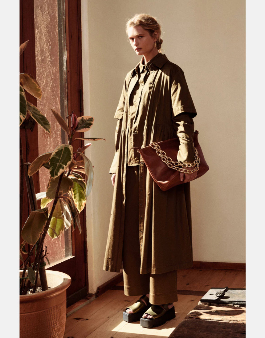 Olive green Elk Stuud long shirt dress displayed on a hanger, showcasing its relaxed fit and casual style.