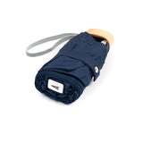 Anatole Colette navy blue micro-umbrella open, lightweight compact umbrella with a curved handle and navy blue canopy.