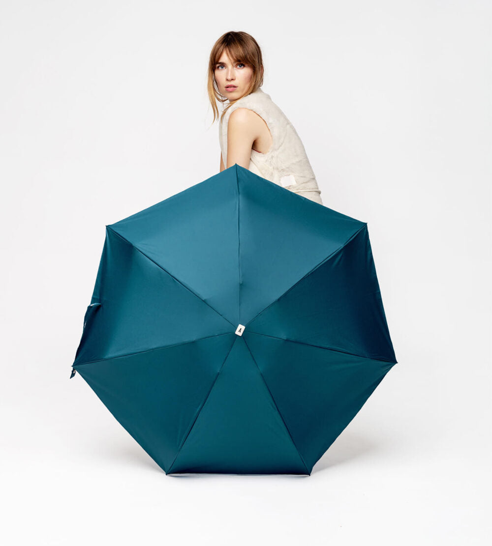 Anatole Octave Micro-Umbrella in mineral blue, open, showing its compact design and vibrant color against a white background.