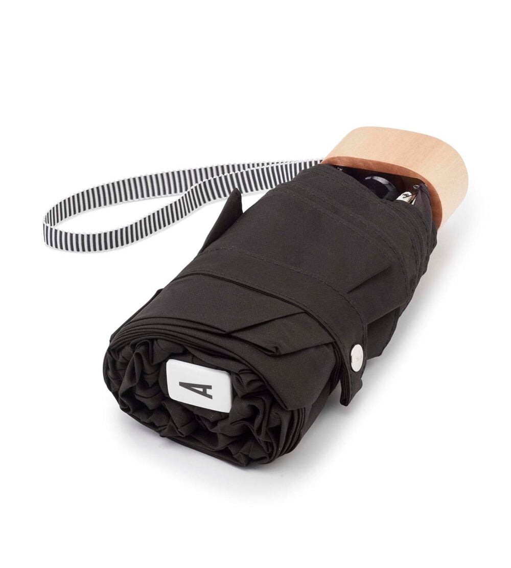 Black Anatole Edwige micro-umbrella with compact design, shown open with chocolate color fabric and no carrying case.