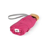 Pink Suzanne micro-umbrella by Anatole with fuchsia canopy and compact pink case, perfect for rain protection and portability.