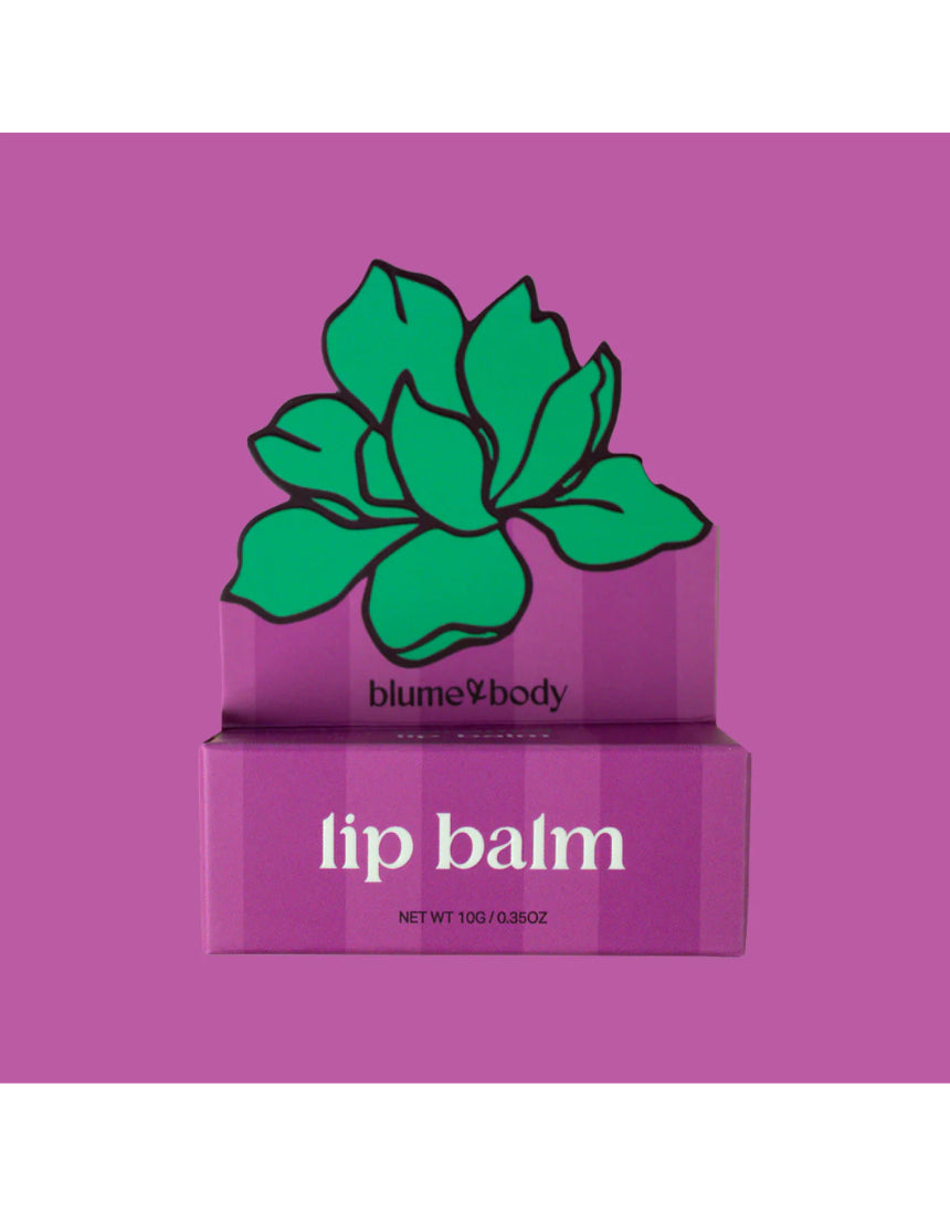 Pink Bloom & Body caramel lip balm in a sleek container with a soft pink lid and smooth caramel-colored balm inside.
