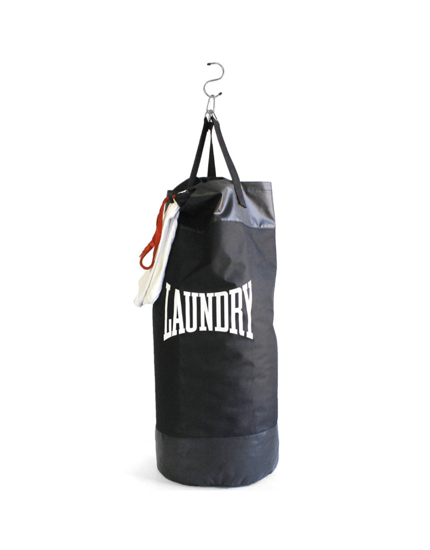 Suck UK Punch laundry bag with bold punch design, made of durable fabric and featuring a sturdy handle for easy carrying.