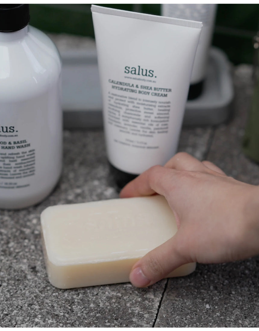 Salus Quintessential Skin Quartet set with assorted soaps featuring natural ingredients and elegant packaging.