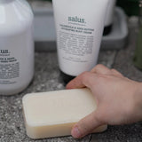 Salus Quintessential Skin Quartet set with assorted soaps featuring natural ingredients and elegant packaging.