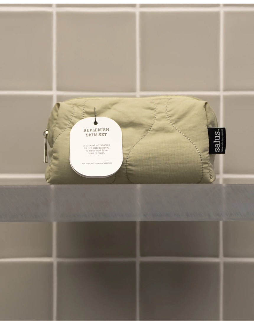 Salus Replenish Skin Set in a sleek bag, featuring skincare products designed to hydrate and rejuvenate the skin.
