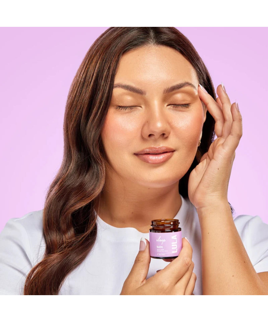 Lula Sleep Balm essential oil jar with a black lid, featuring lavender and herbal ingredients for relaxation and sleep.