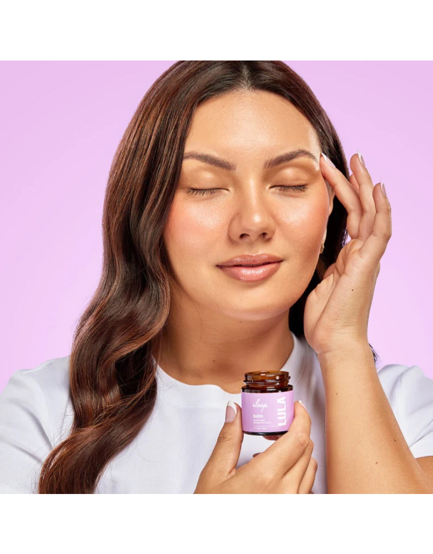 Lula Sleep Balm essential oil jar with a black lid, featuring lavender and herbal ingredients for relaxation and sleep.