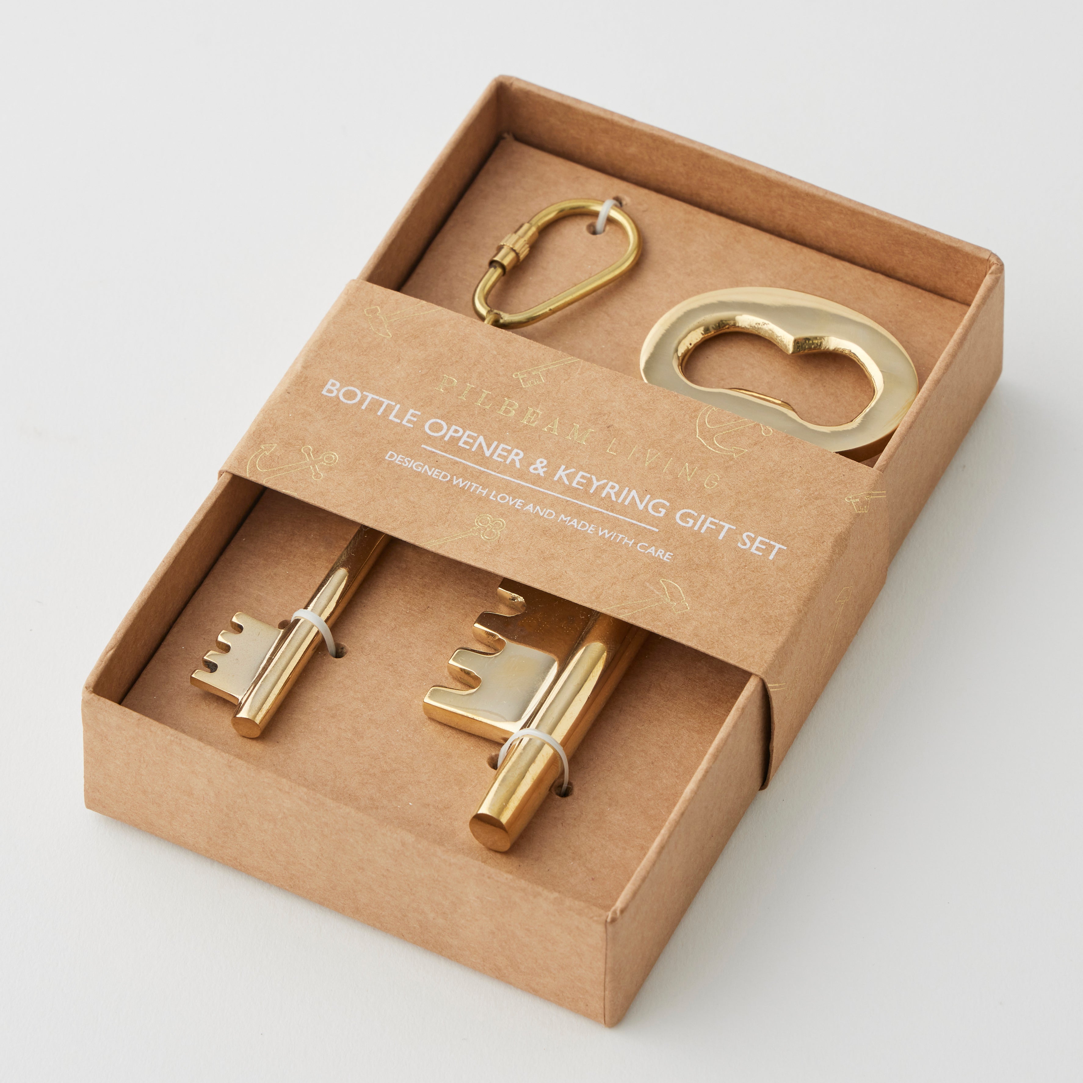 Pilbeam Living gold key bottle opener and keyring set, stylish metal design with keychain and bottle opener in a gift-ready set.