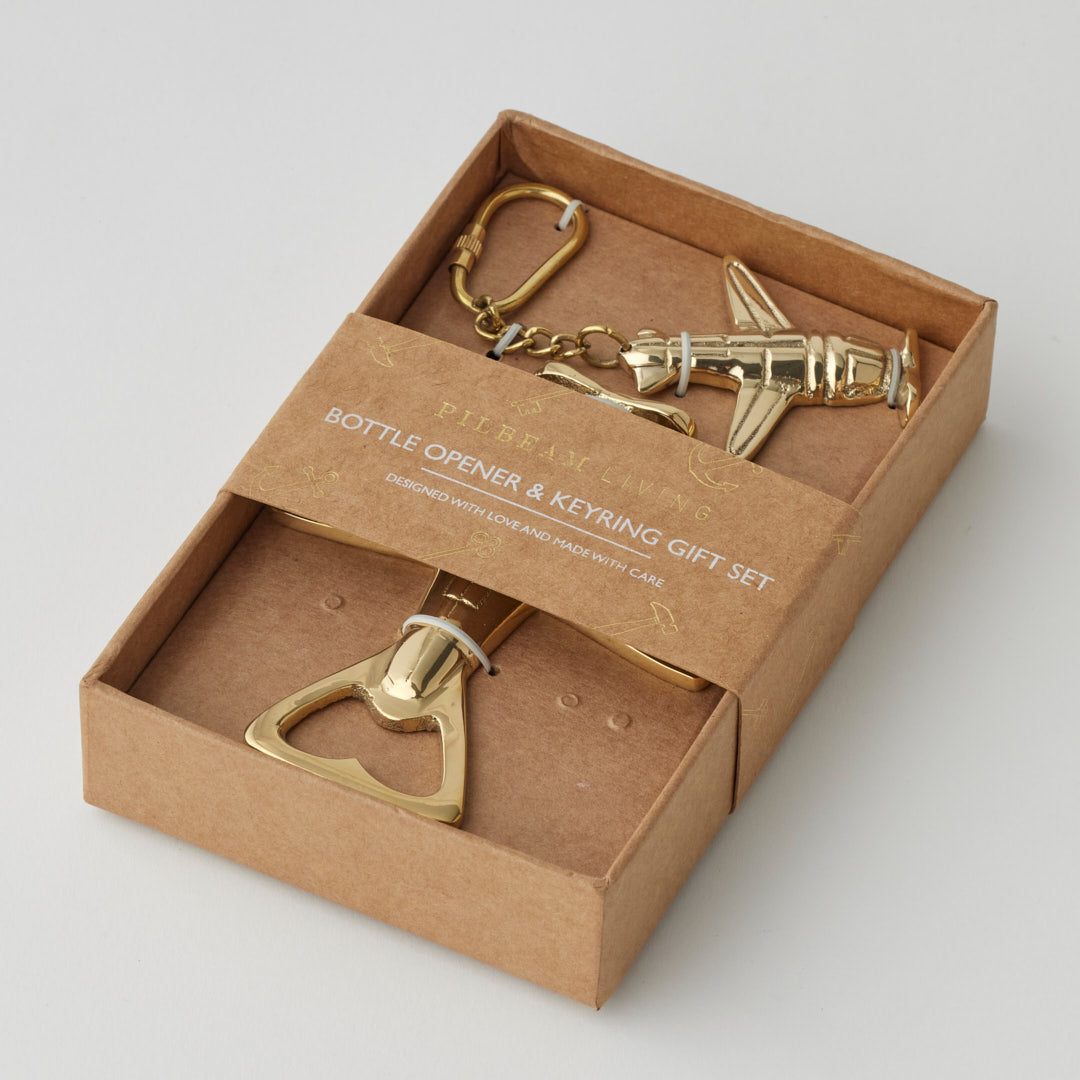 Pilbeam Living gold plane-shaped bottle opener and keyring set, stylish and functional gift set with aviation-inspired design.