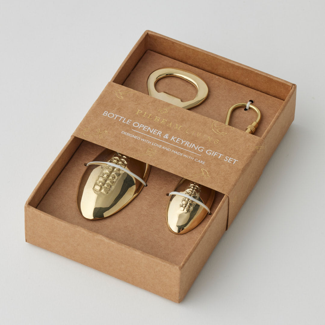 Gold football-shaped bottle opener and keyring set by Pilbeam Living, stylish and functional gift set with football design.