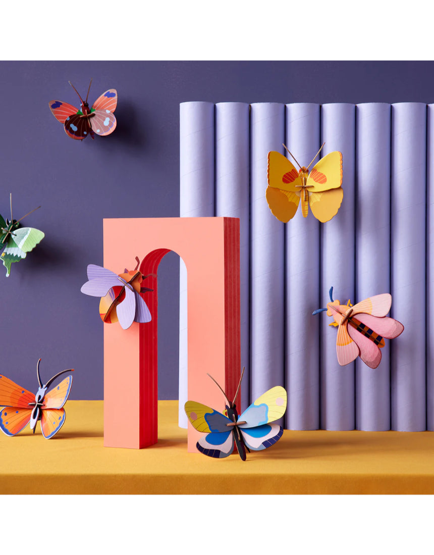 Yellow butterfly wall art by Studio Roof featuring vibrant butterflies on a decorative wall decor piece.