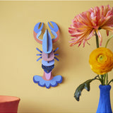 Studio Roof wall art featuring a vibrant lobster sea creature in a decorative wall decor piece.