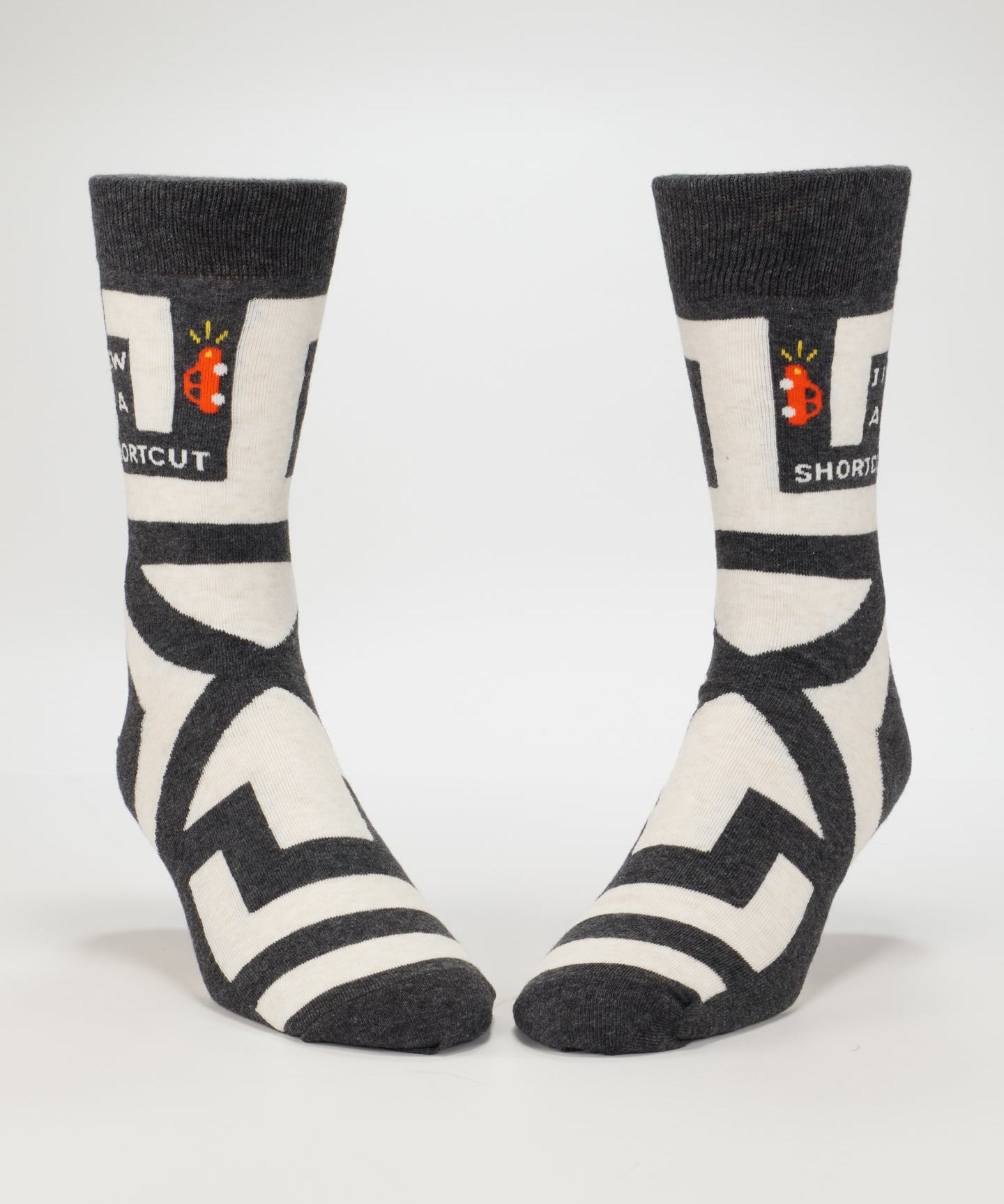 Blue Q men's crew socks featuring the "I Know A Shortcut" design with colorful patterns on soft fabric.