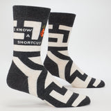 Blue Q men's crew socks featuring the "I Know A Shortcut" design with a blue color and fun printed pattern.