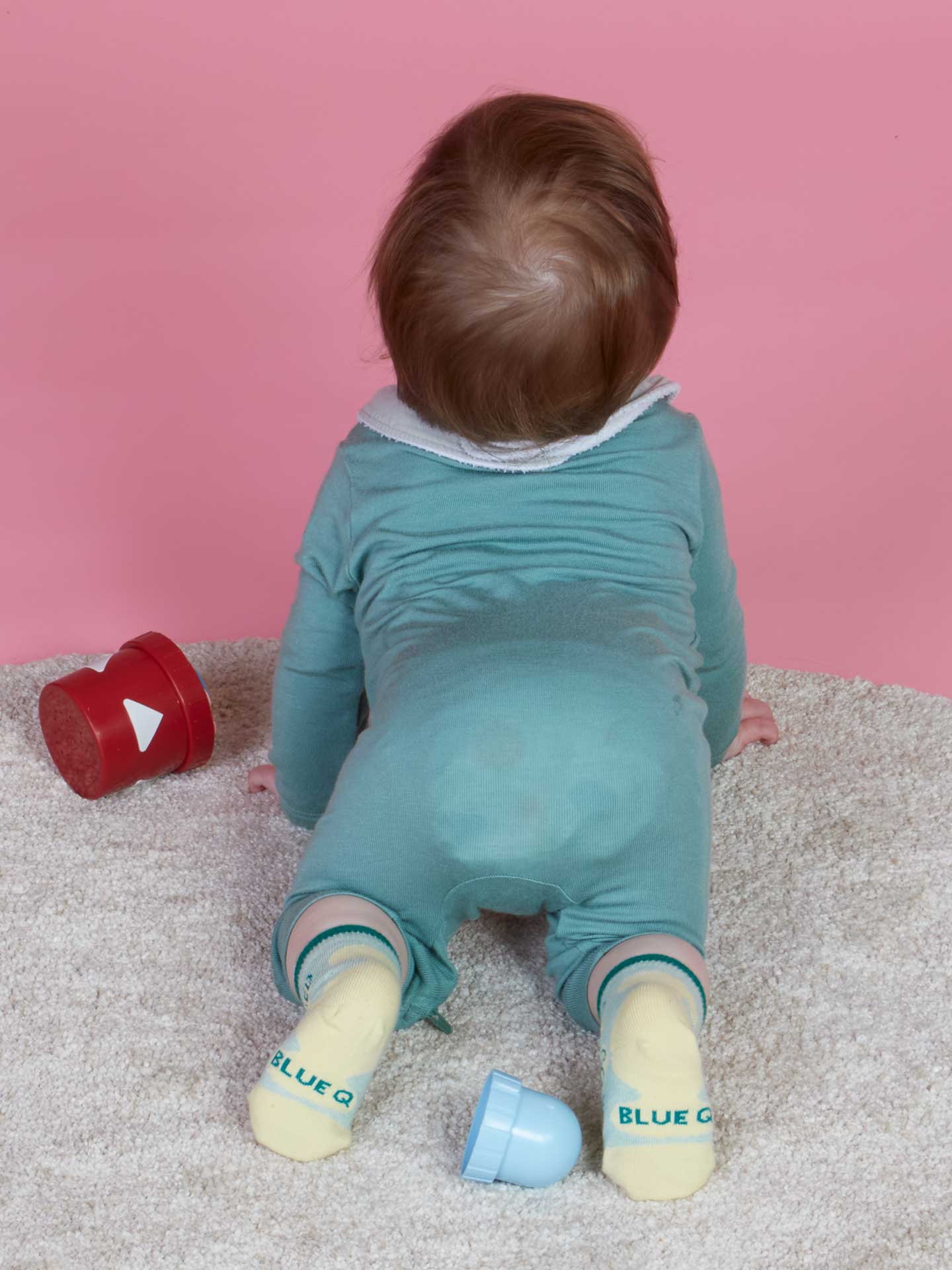 Blue Q baby socks featuring Cuddle Bug and Cry Baby designs, soft fabric and colorful patterns for infants.