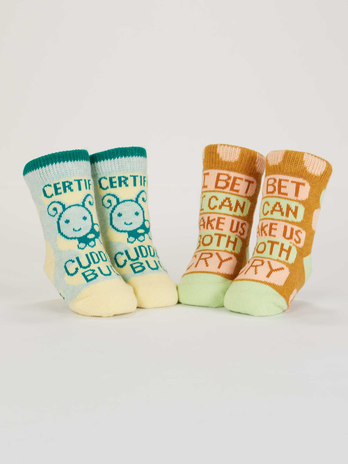 Blue Q baby socks featuring Cuddle Bug and Cry Baby designs, shown from the back view. Soft, colorful sock pair for infants.