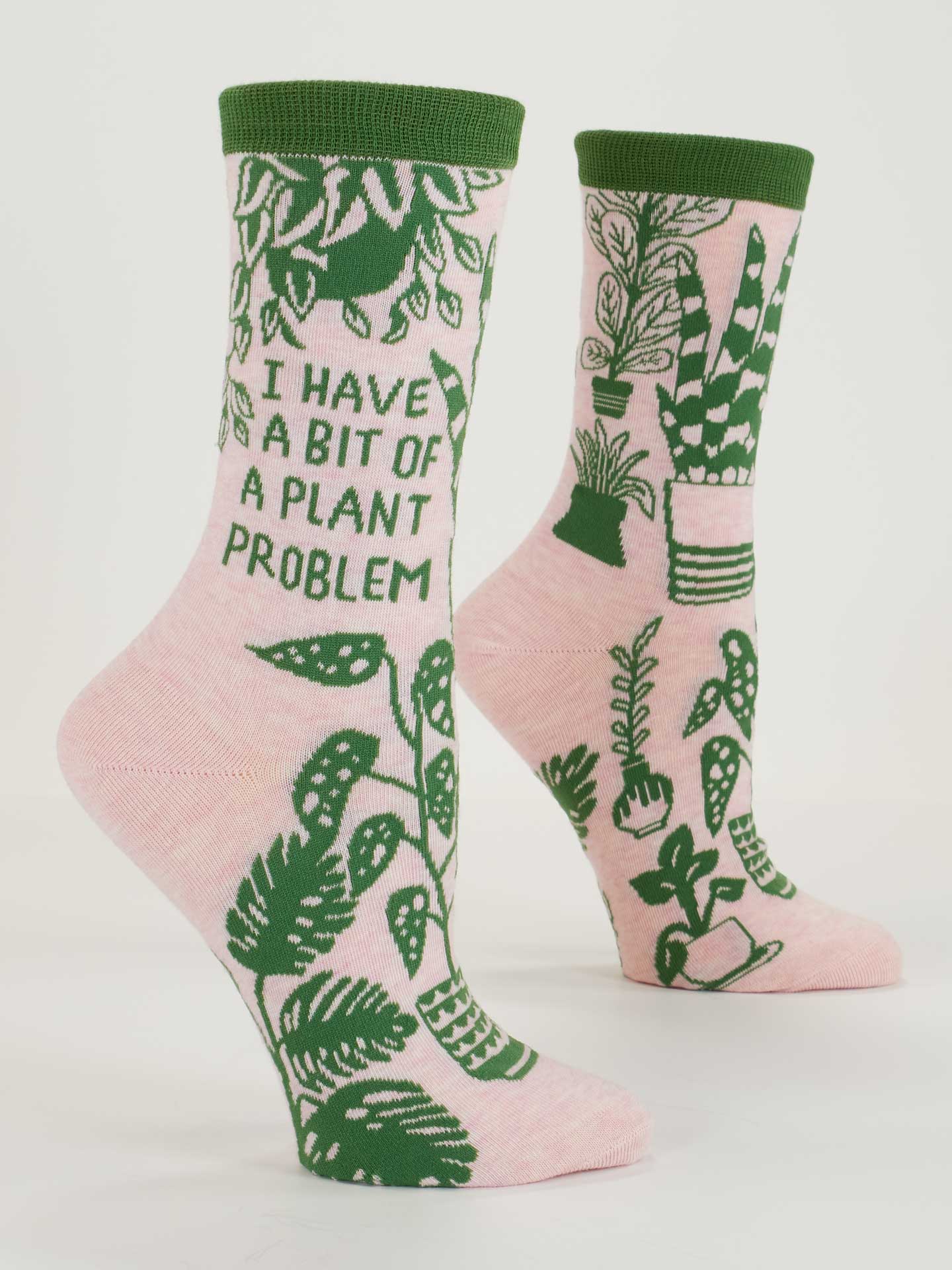 Blue Q ladies crew socks featuring a plant-themed design with the phrase "I Have A Bit Of A Plant Problem" on a light background.