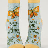 Blue Q ankle socks featuring a colorful, humorous "Shitstorm" design, made of soft fabric for comfortable wear.