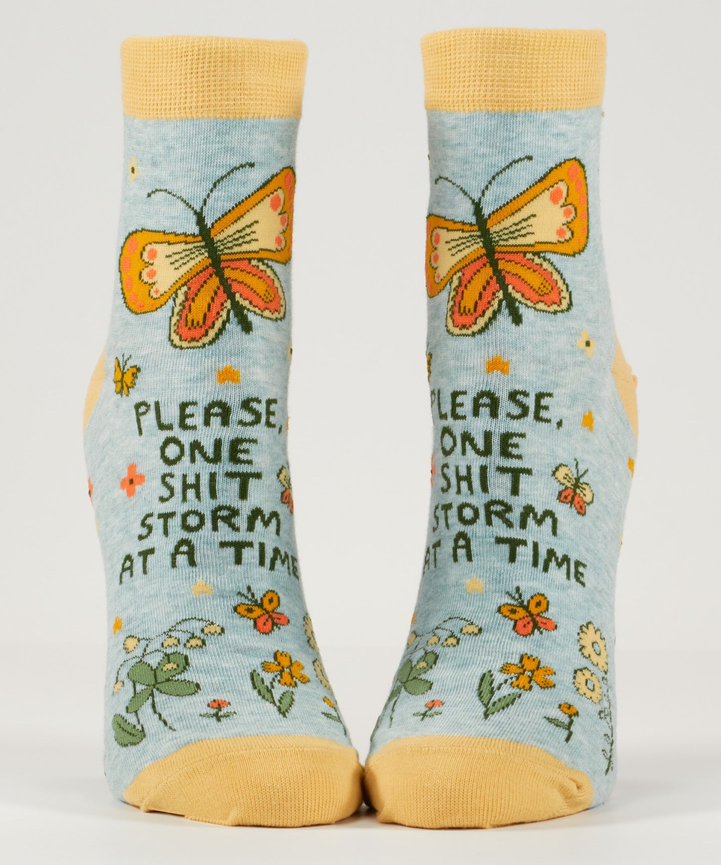 Blue Q ankle socks featuring a colorful, humorous "Shitstorm" design, made of soft fabric for comfortable wear.