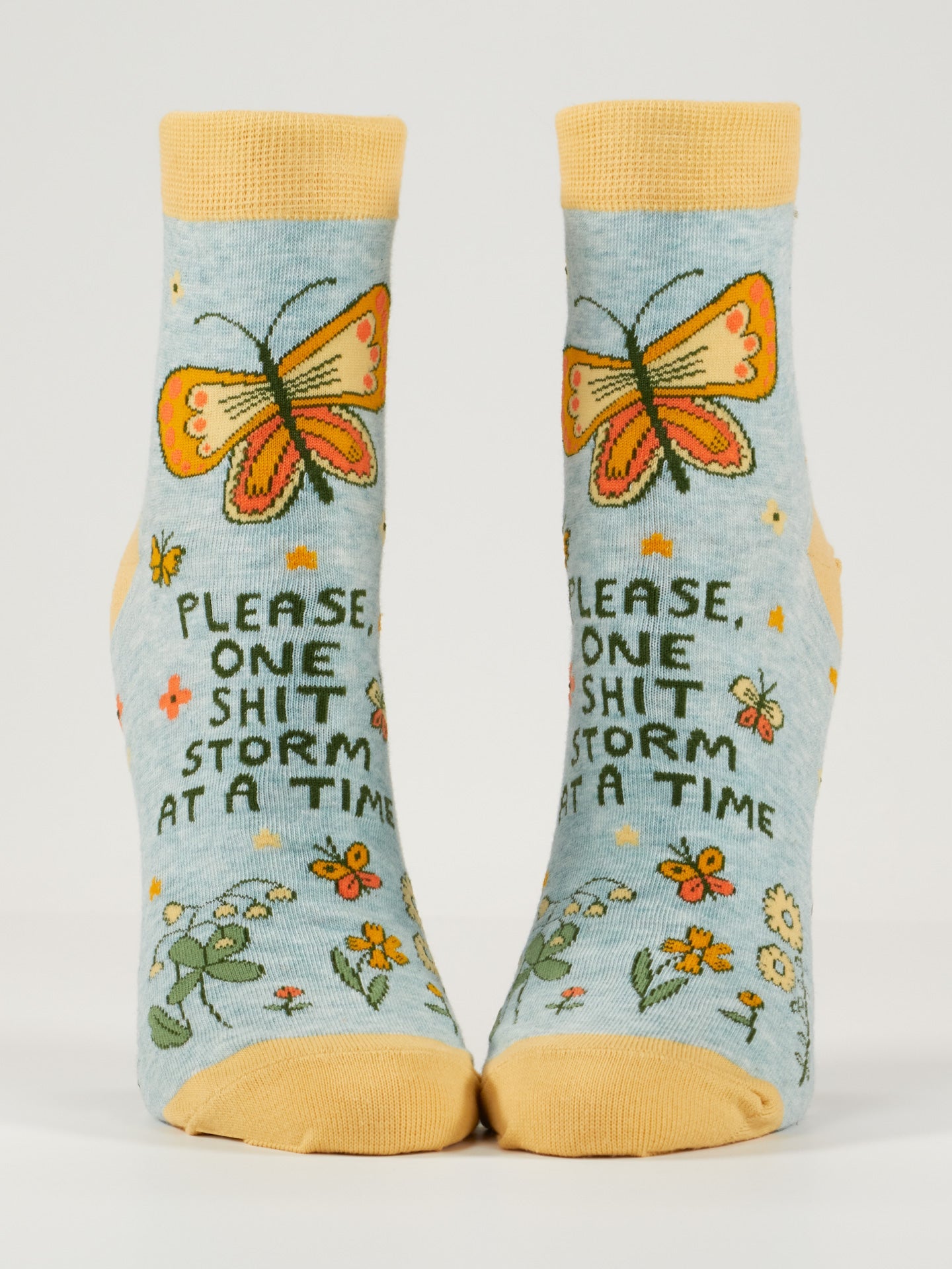 Blue Q ankle socks featuring a colorful, humorous "Shitstorm" design, made of soft fabric for comfortable wear.