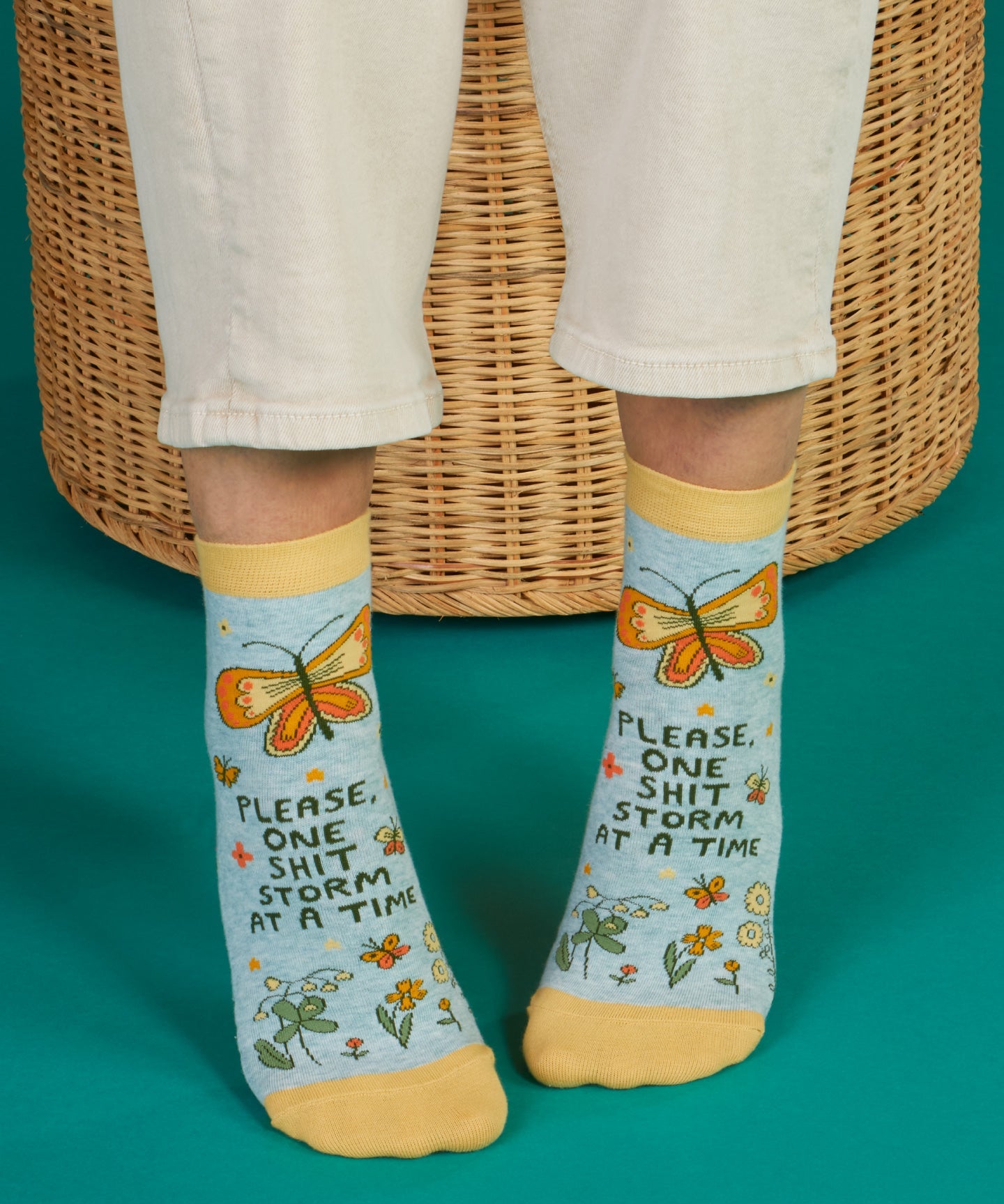 Blue Q ankle socks featuring a colorful "Shitstorm" design, made from soft fabric for comfortable wear.